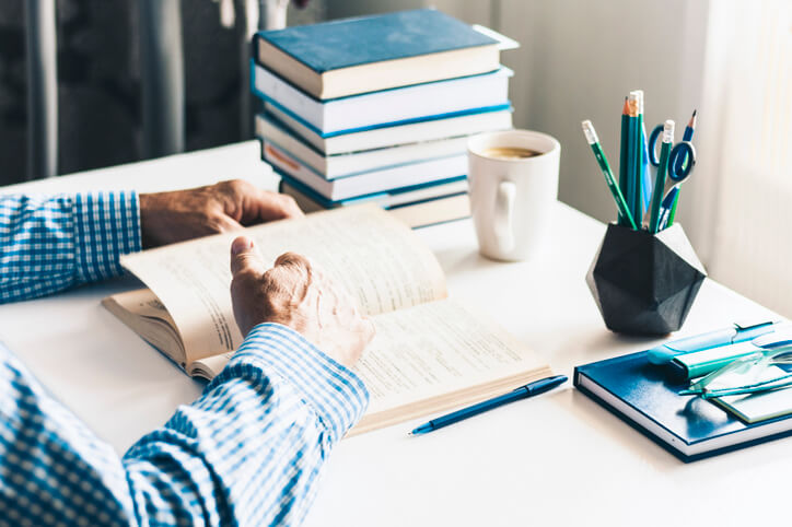 Man Reading a Book in His Home Office