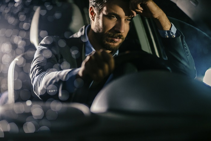 Man driving home drunk and tired