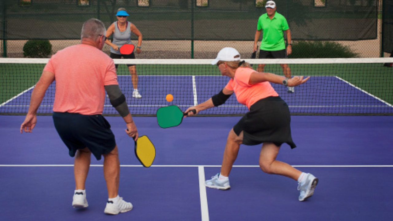 A Young Paddle Tennis Player Catching The Ball With The Racket