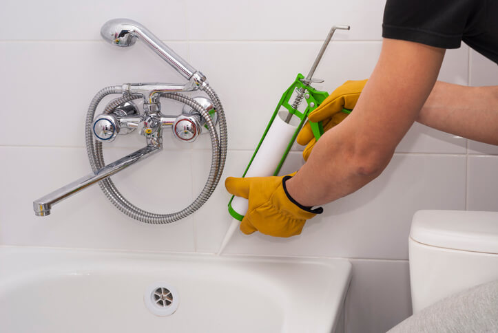 Caulk around tubs to prevent plumbing leaks