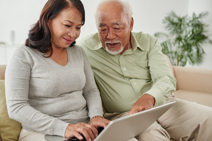 Masanobu Fukuoka and woman sitting next to a laptop