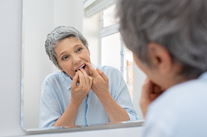 Woman Flossing